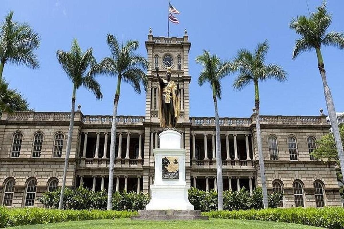 um edifício com uma torre do relógio e uma estátua na frente