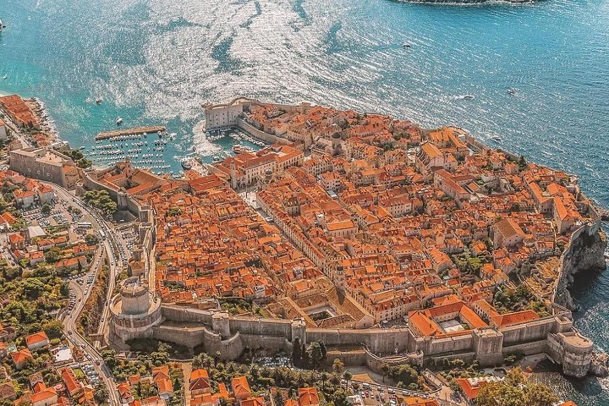 an aerial view of a city next to the ocean