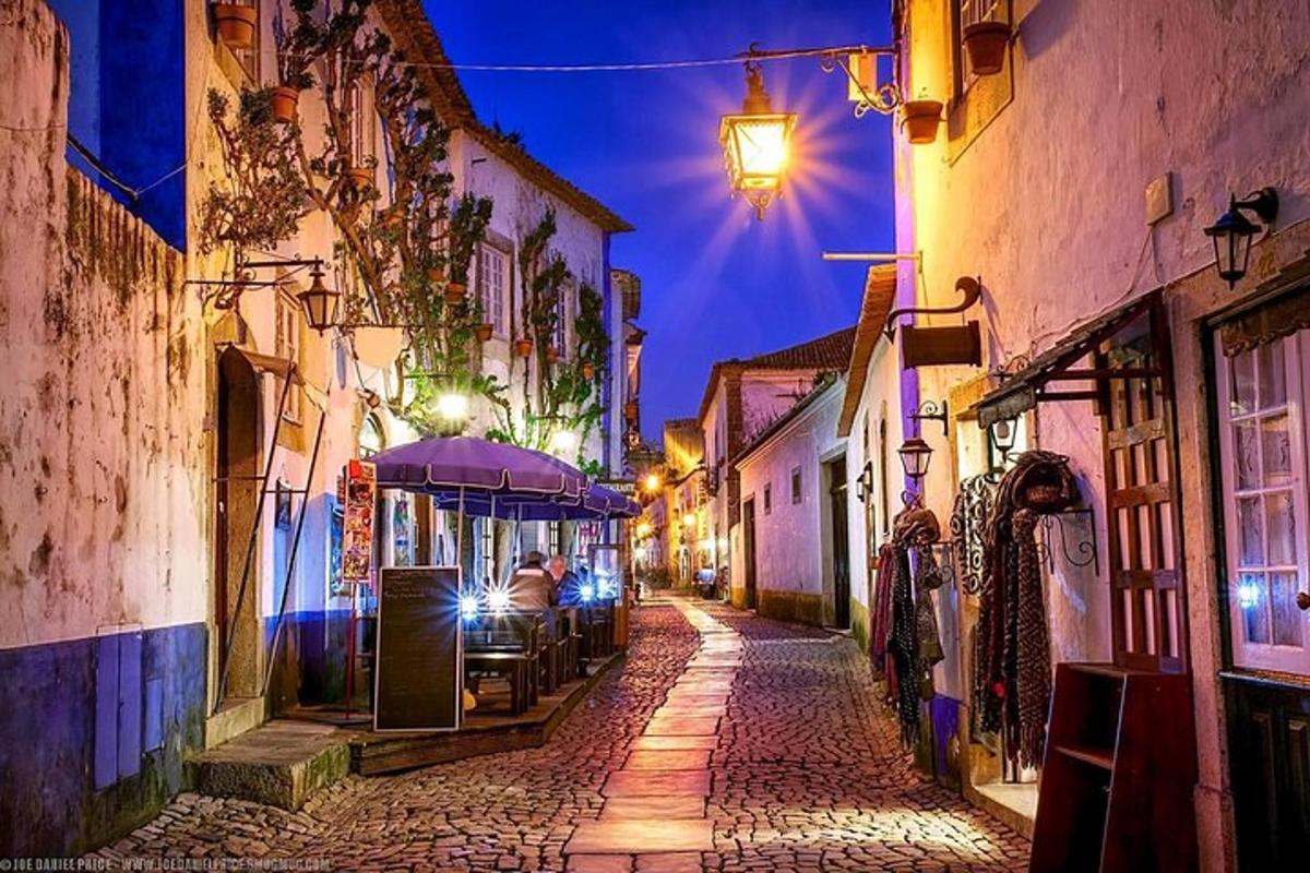 eine gepflasterte Straße in der Nacht in einer Altstadt