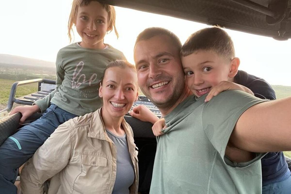 un uomo, una donna e due bambini sul retro di un veicolo