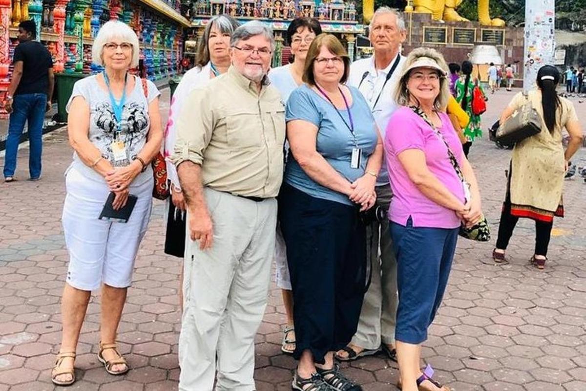 a group of people posing for a picture on a street