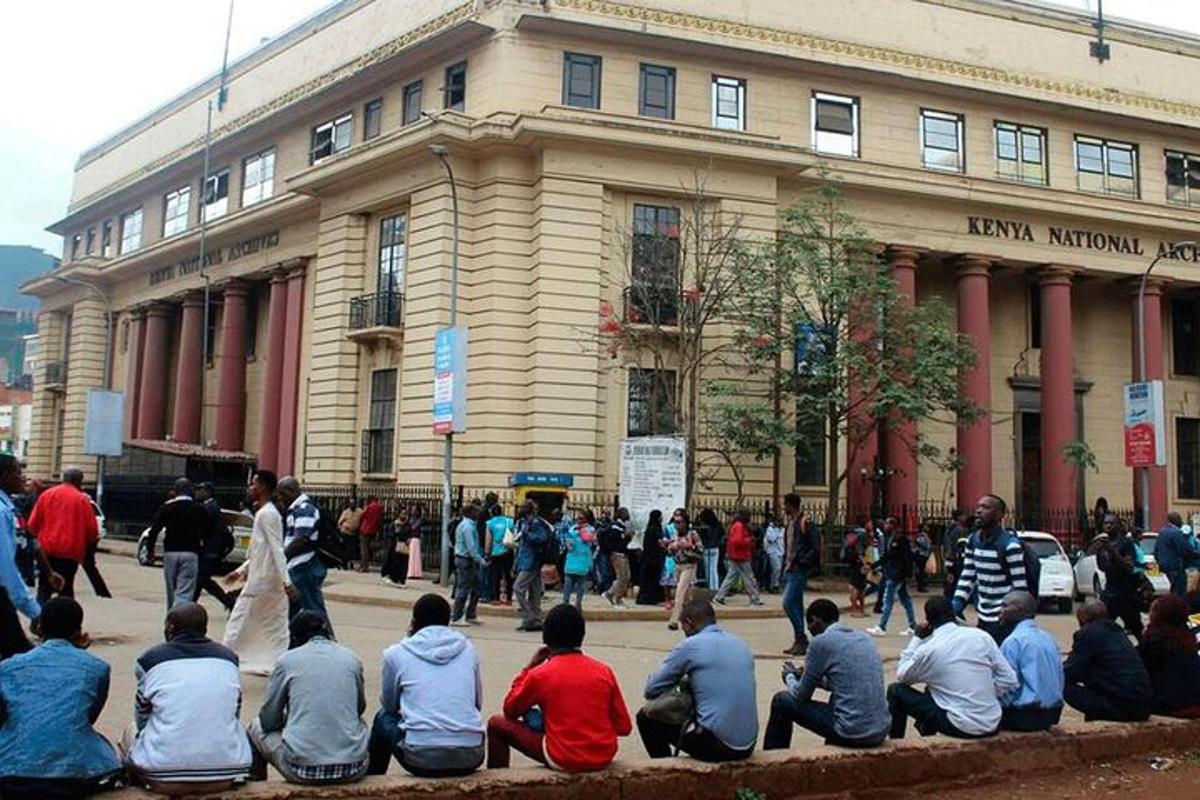 a group of people sitting in front of a building