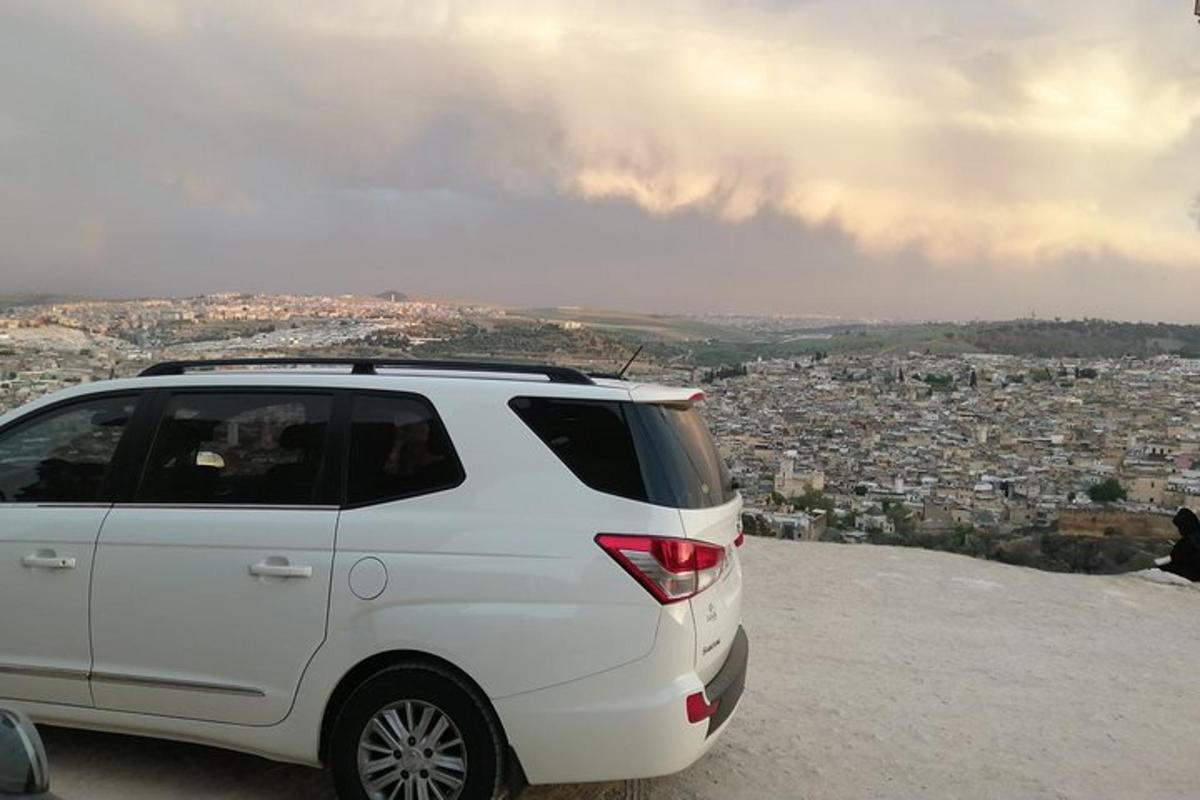 Ένα λευκό SUV παρκαρισμένο στην κορυφή ενός βουνού