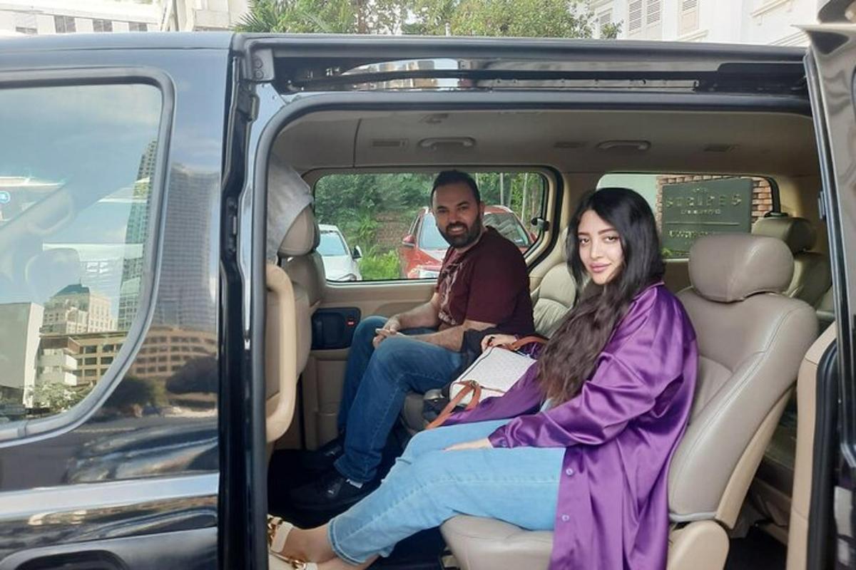 a man and a woman sitting in the back of a van