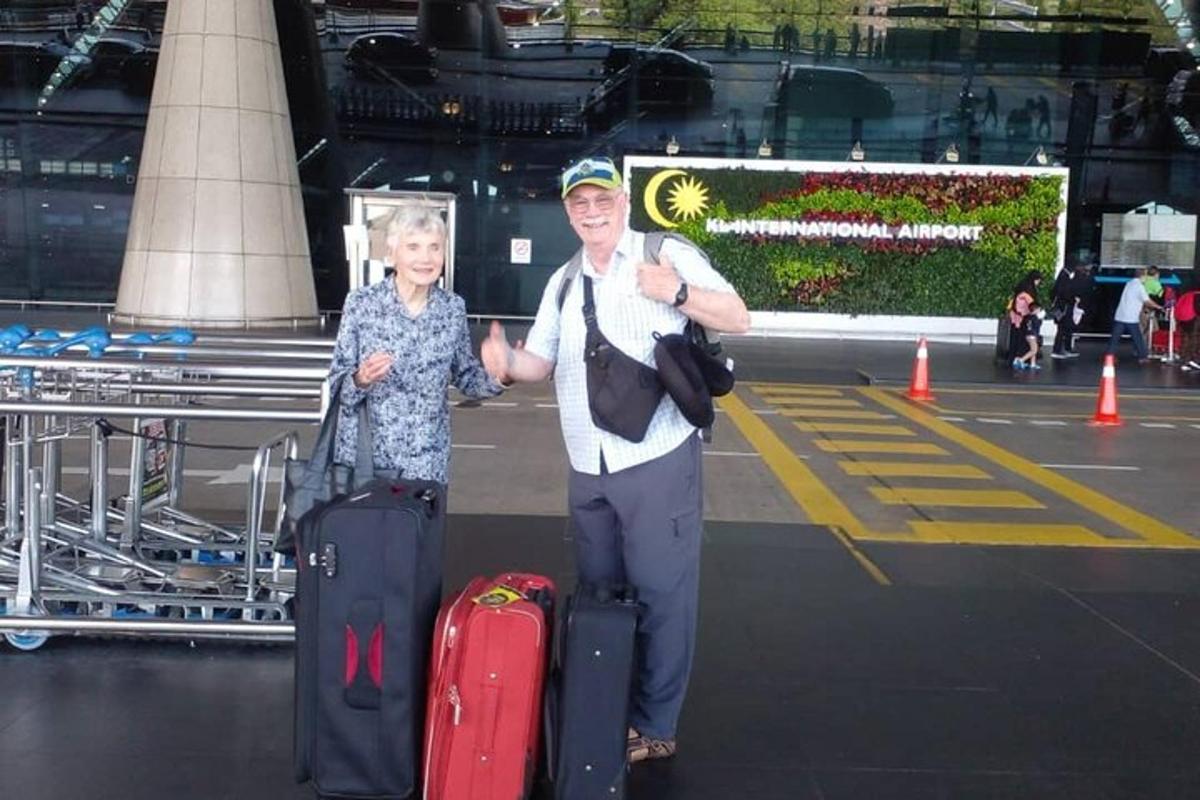 a man and a woman with luggage at an airport