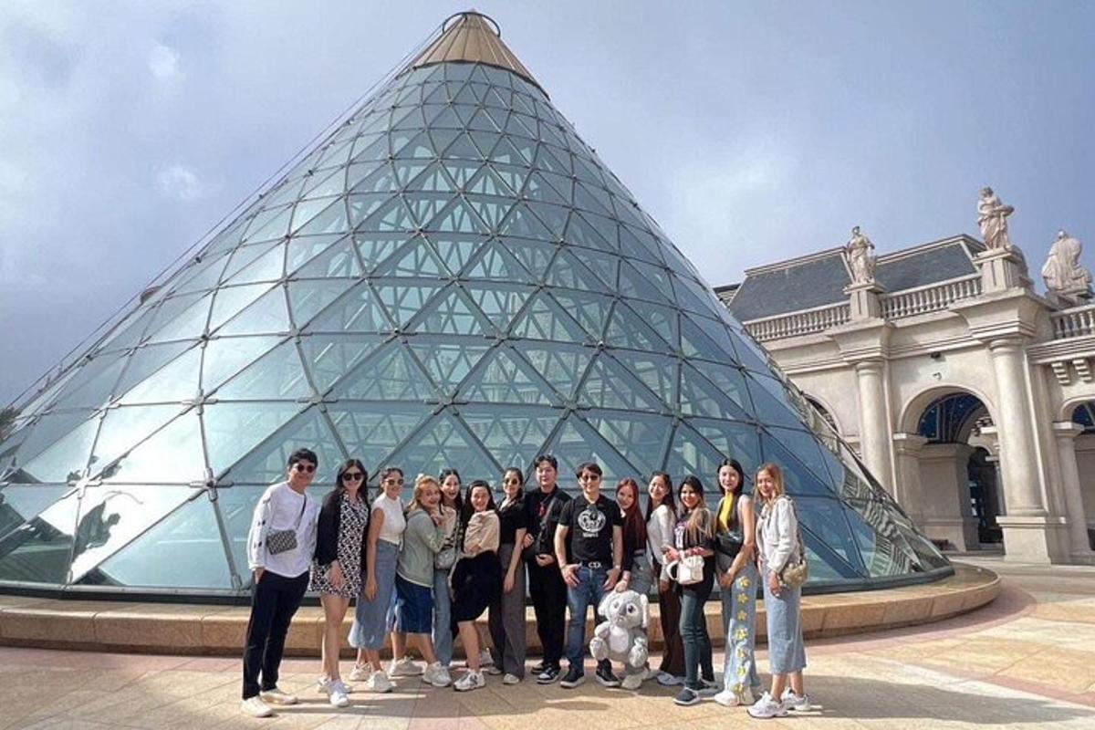 skupina ľudí stojacich pred pyramídou