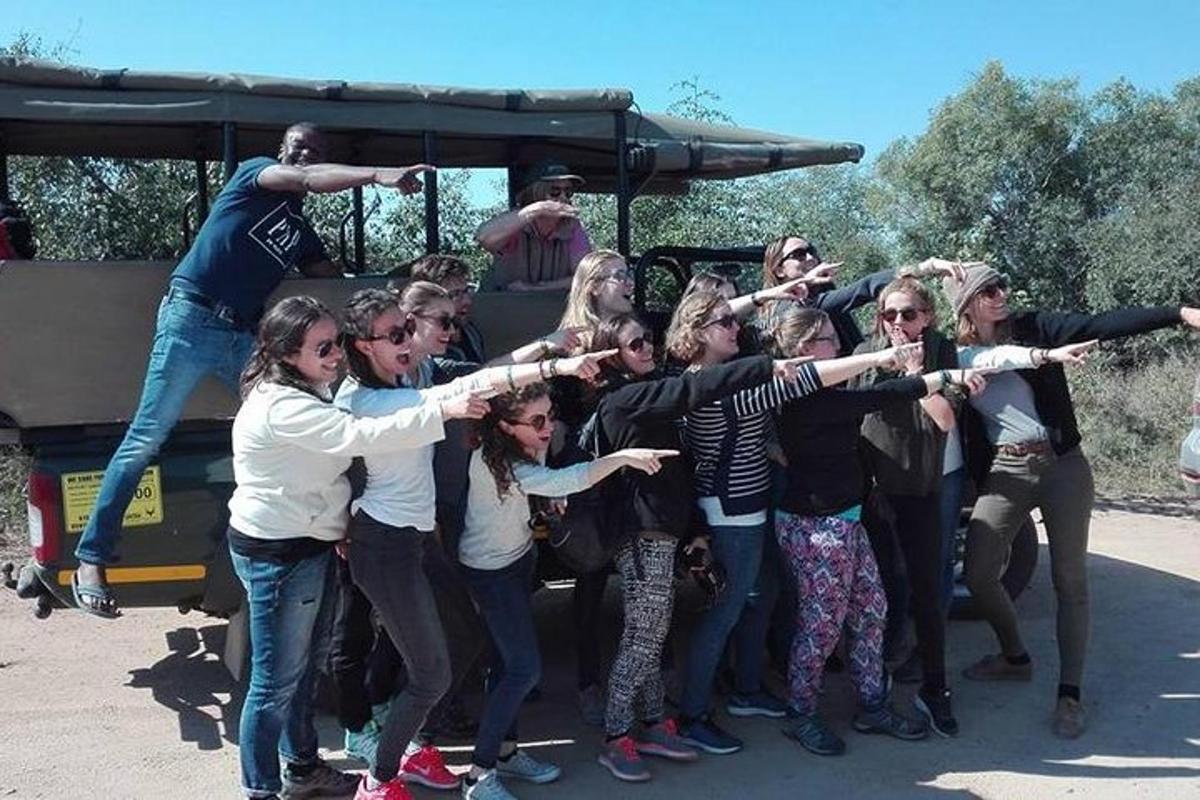 a group of people standing in front of a bus