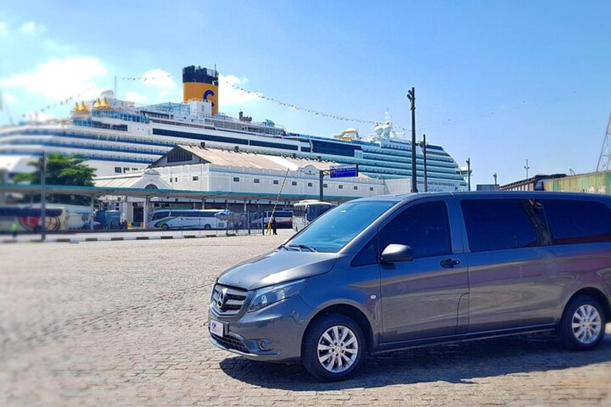 a van parked in front of a cruise ship