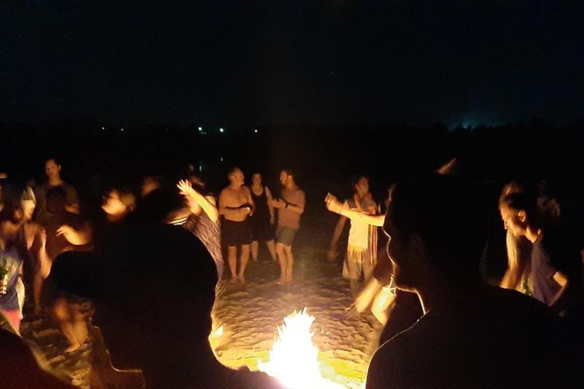 hópur fólks stendur í kringum eldgryfju