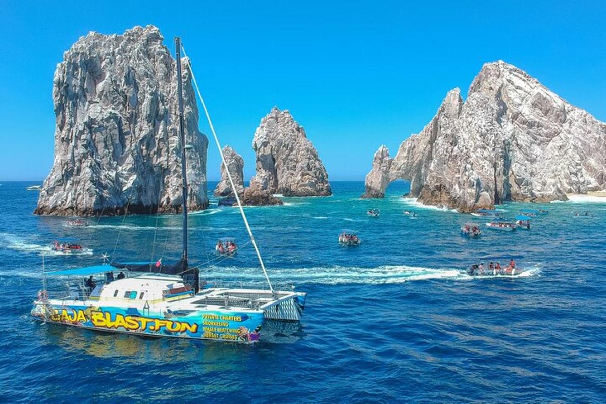a boat in the water next to some rocks