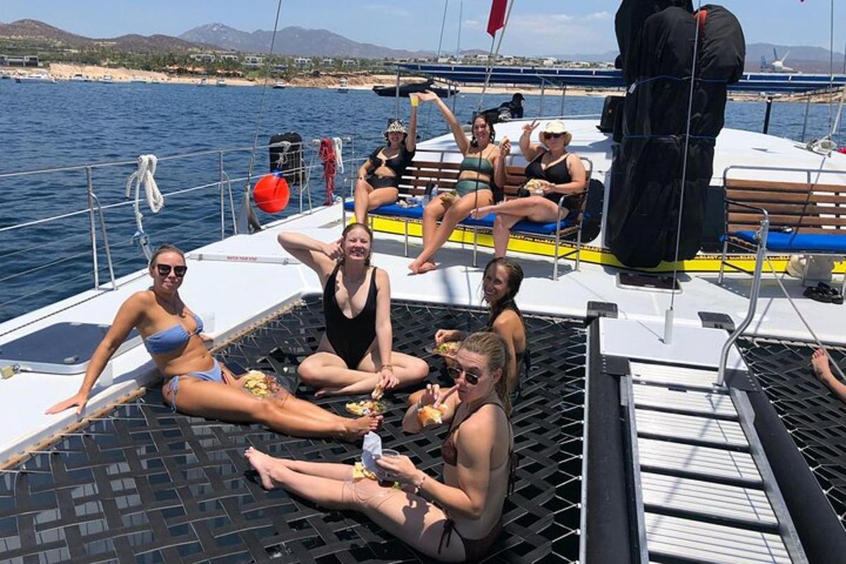a group of women sitting on the deck of a boat