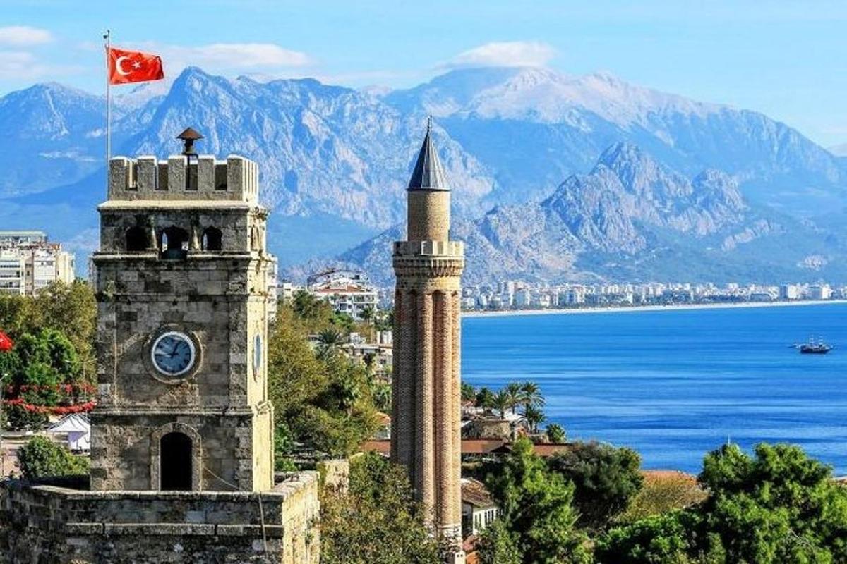 una torre del rellotge amb una bandera davant d'una ciutat