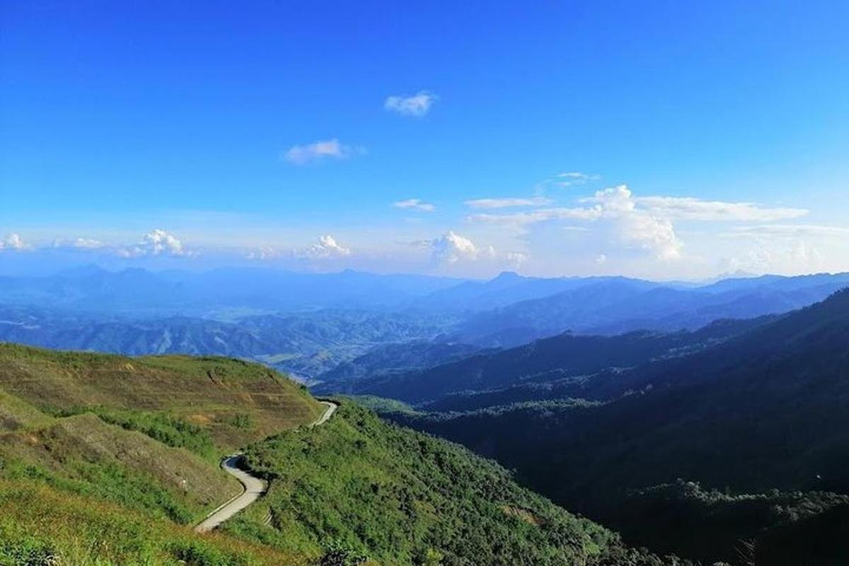a view of a valley with a road on a mountain