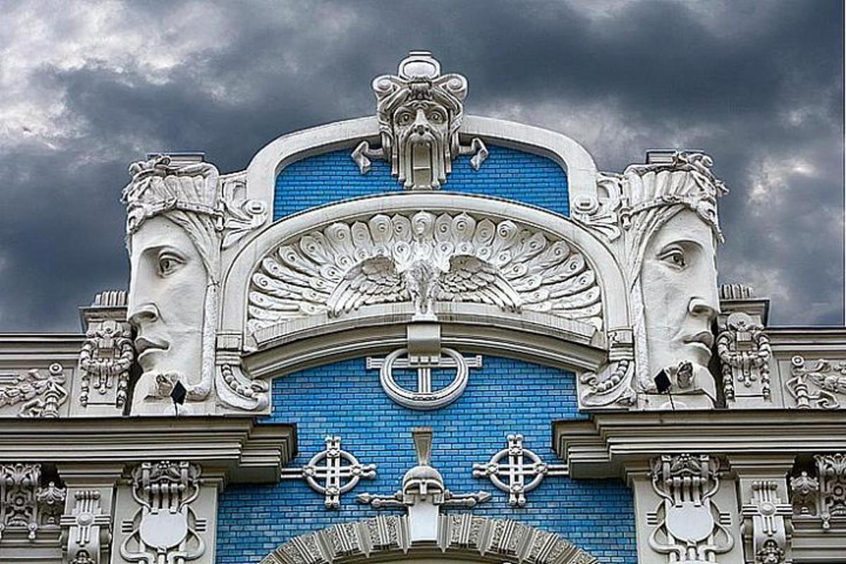 a blue building with two faces on top of it