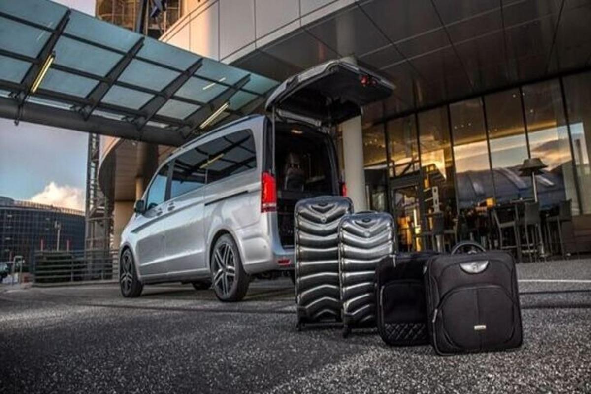 a van with luggage sitting in front of a building