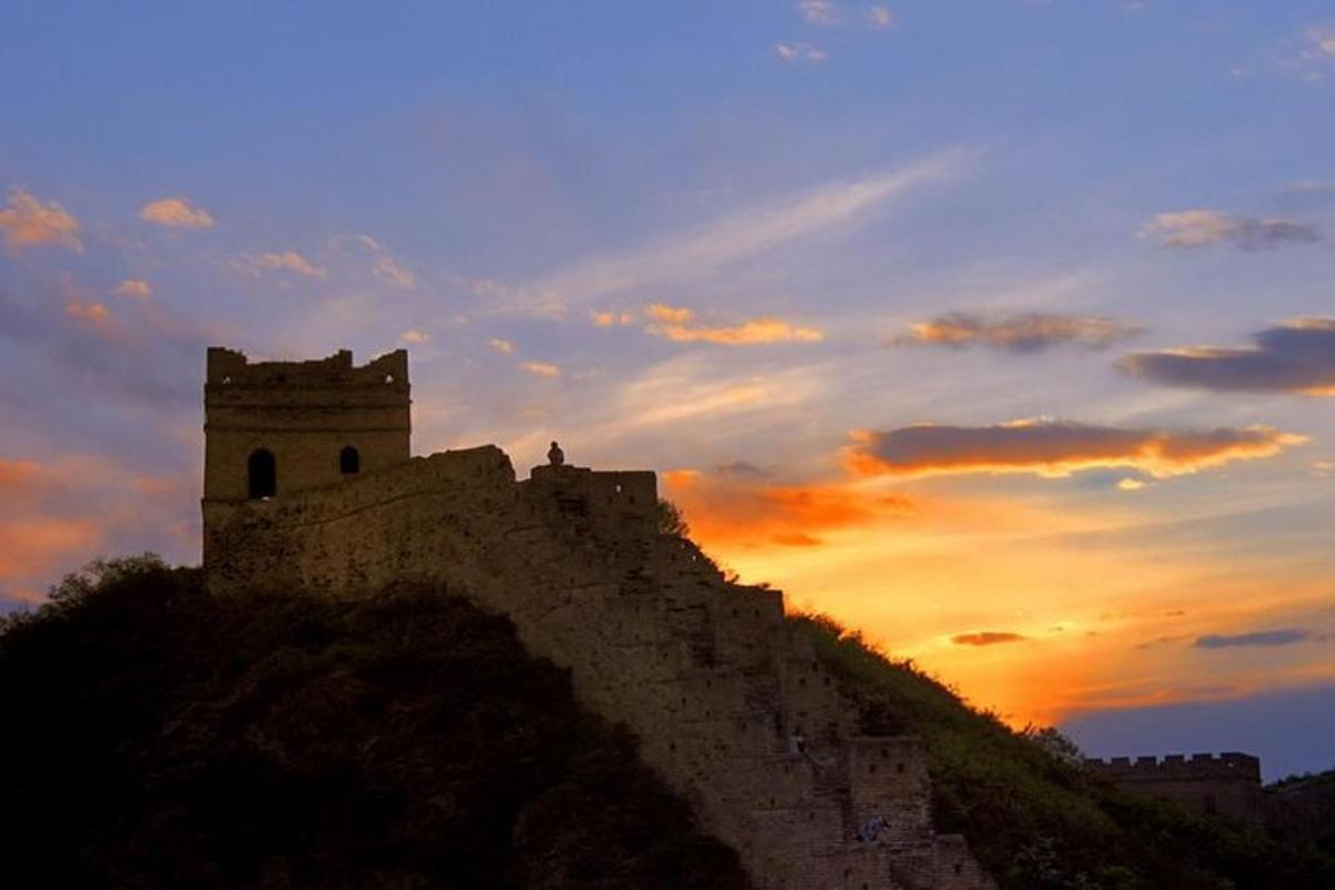 a castle on top of a hill at sunset