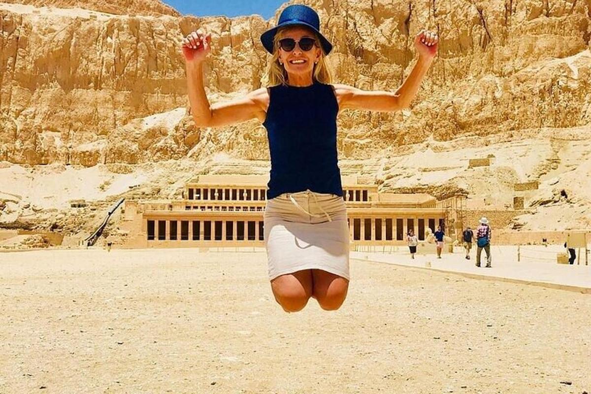 una donna che salta in aria davanti a un edificio