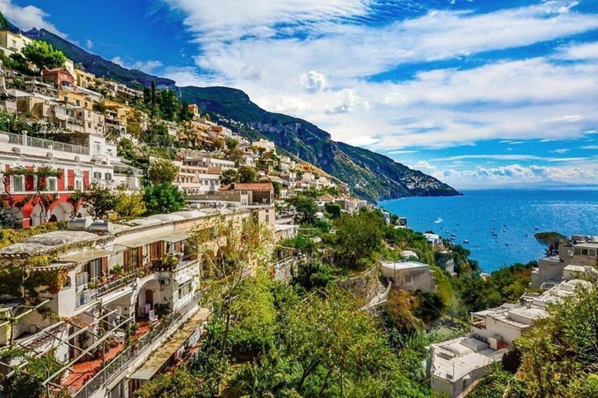 a group of buildings on a hill next to the ocean