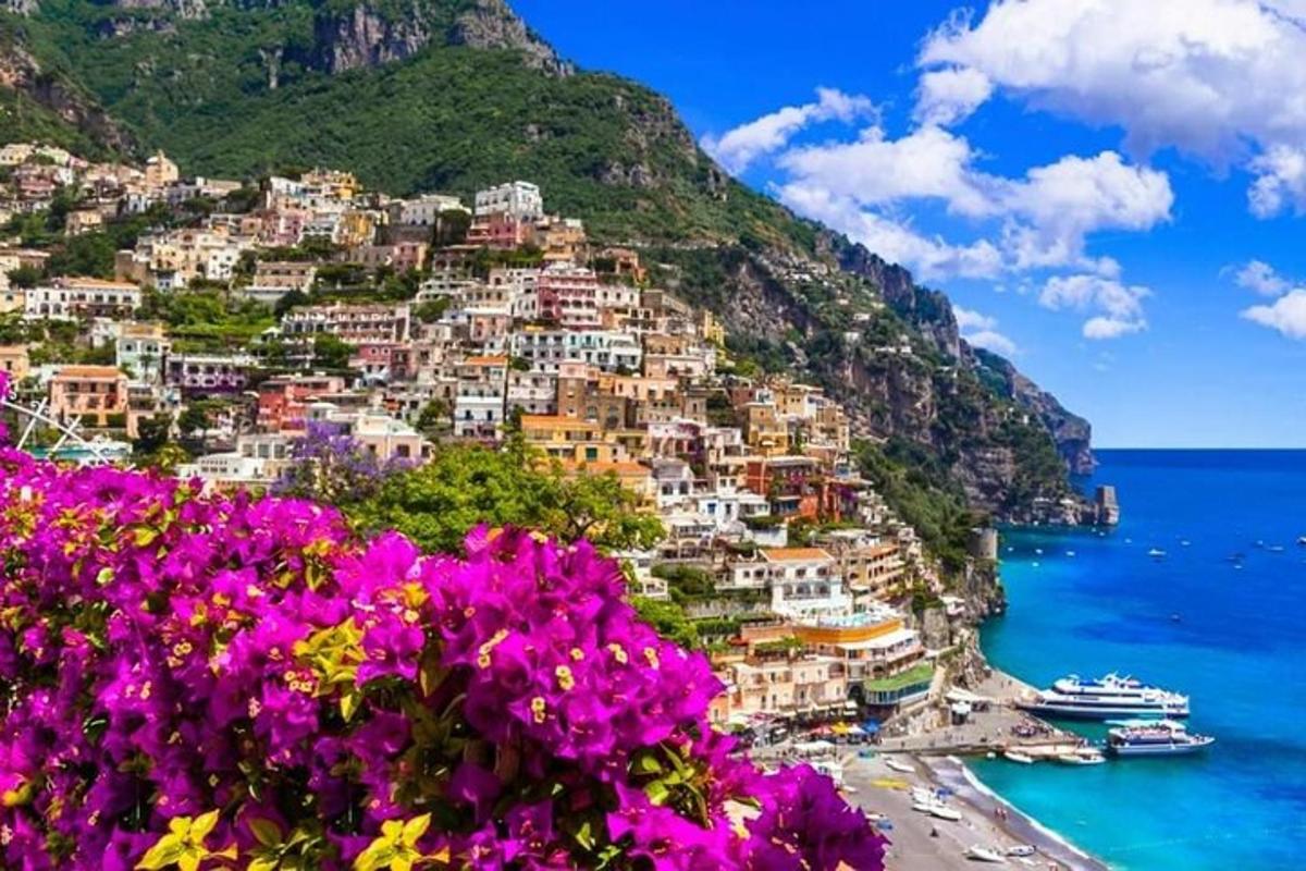 a view of the amalfi coast with purple flowers