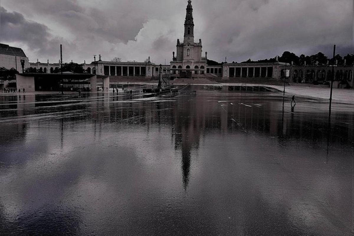 a black and white photo of a building with a clock tower