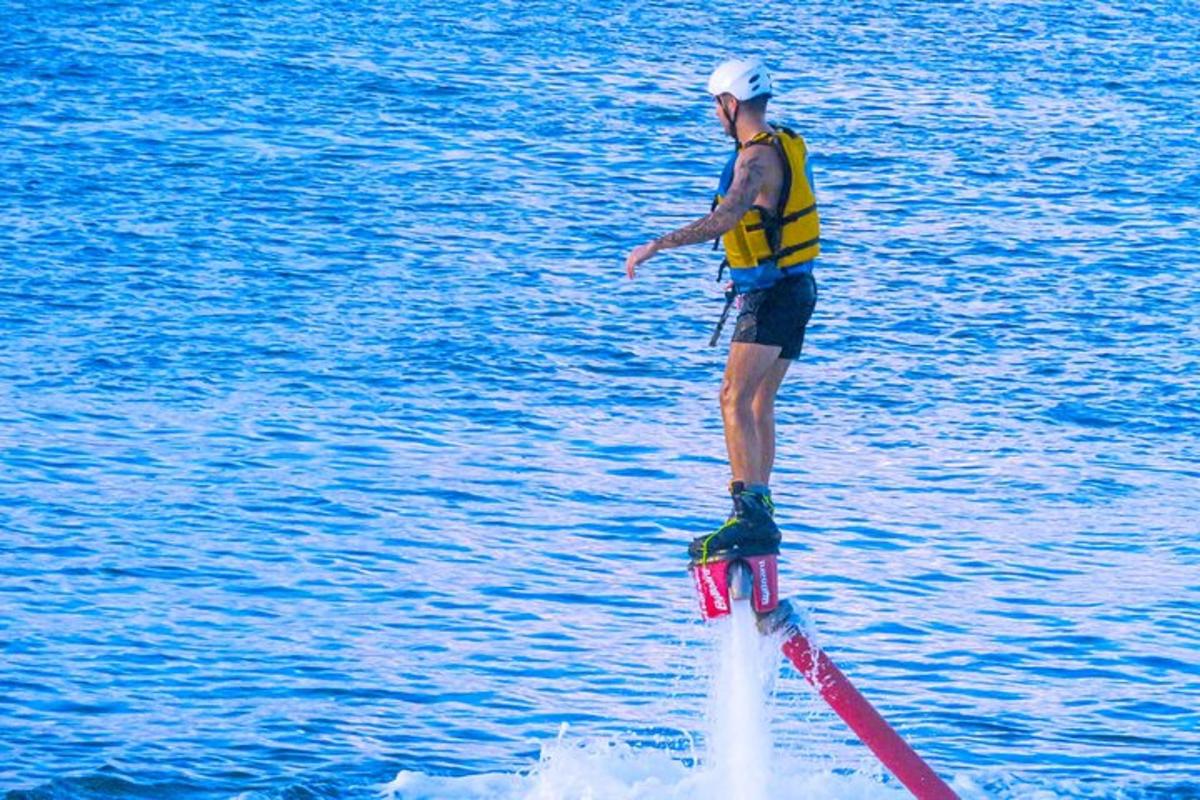a man standing on a water board in the water