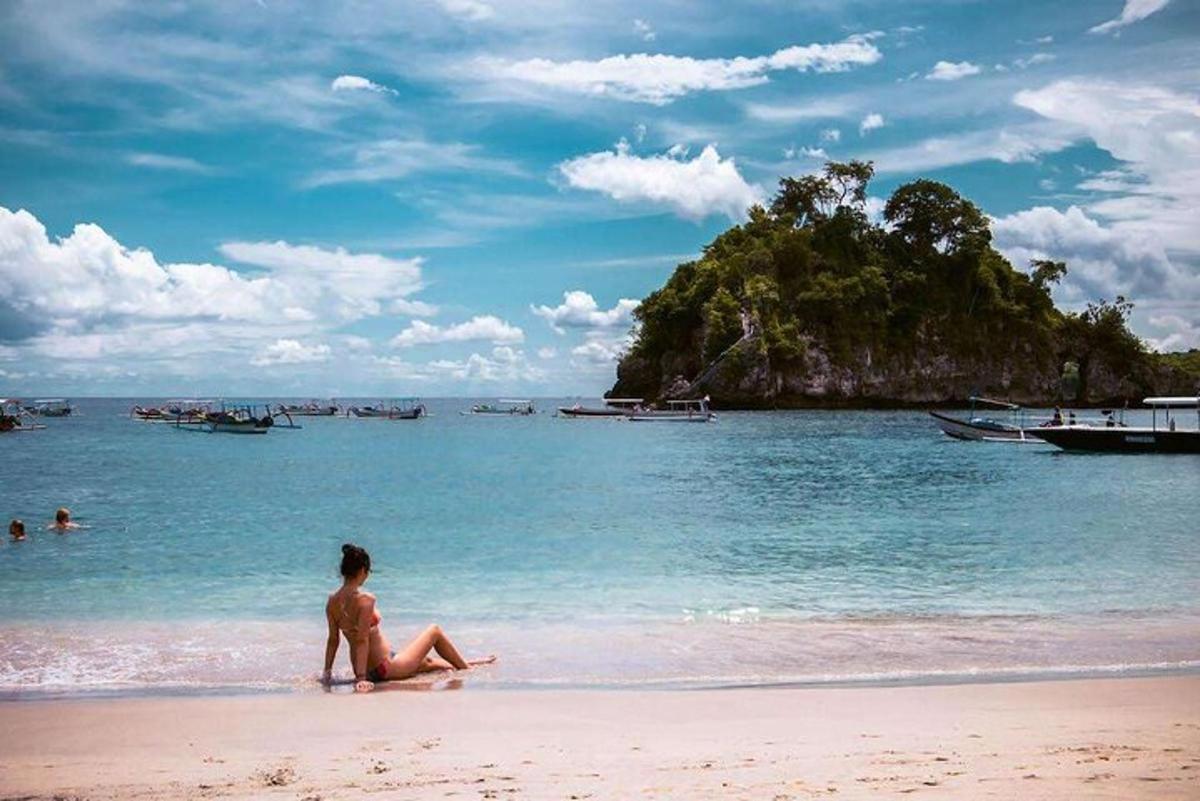 a person sitting on a beach in the water