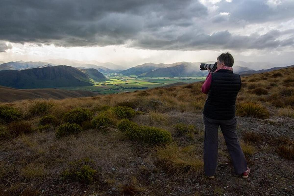 a person taking a picture of a mountain with a camera