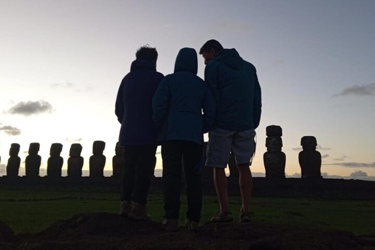 three people standing in front of an ancient monument