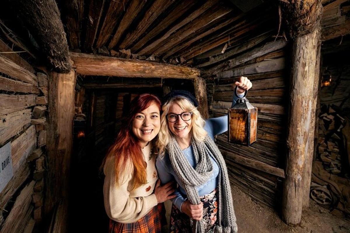 two women standing in a cabin with a bottle