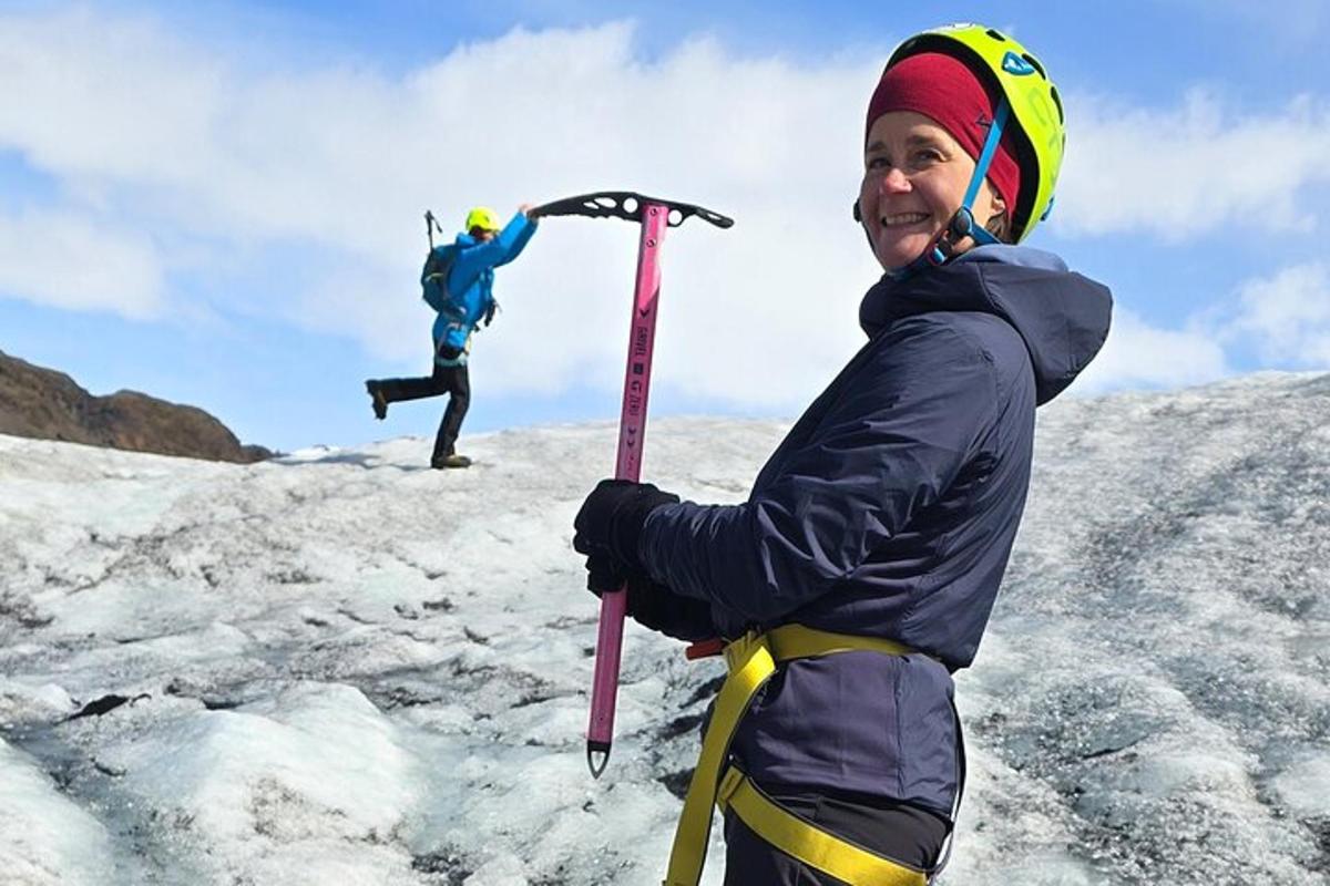 two people standing on top of a mountain with skis