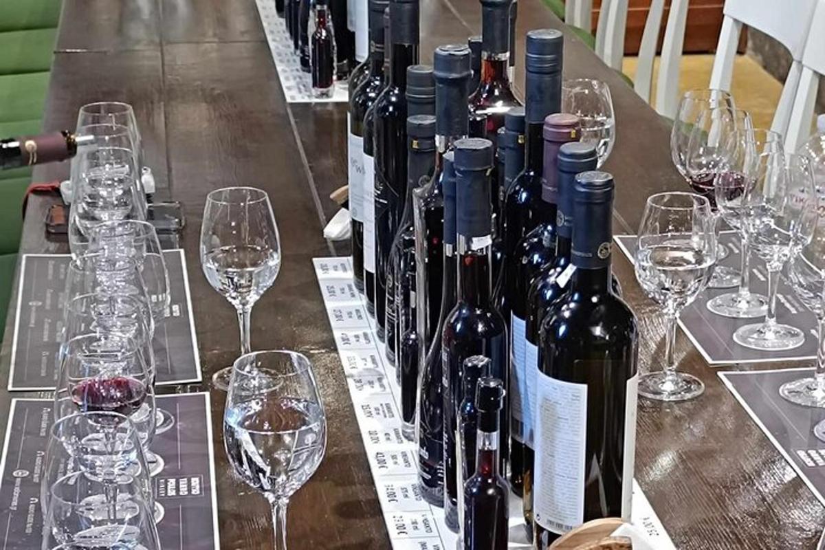 a table with wine bottles and glasses on it