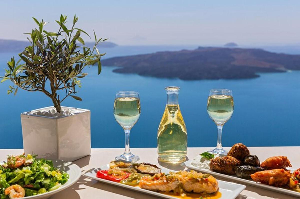 ένα τραπέζι με δύο πιάτα φαγητού και δύο ποτήρια κρασί