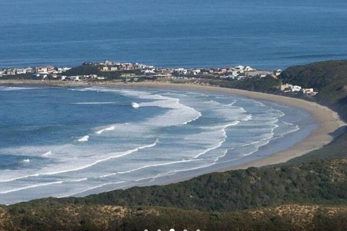 an aerial view of a beach with the ocean