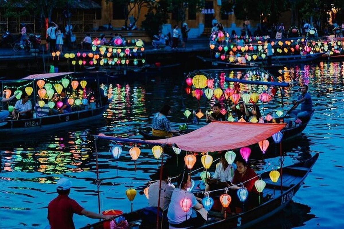 a group of boats with lights on the water