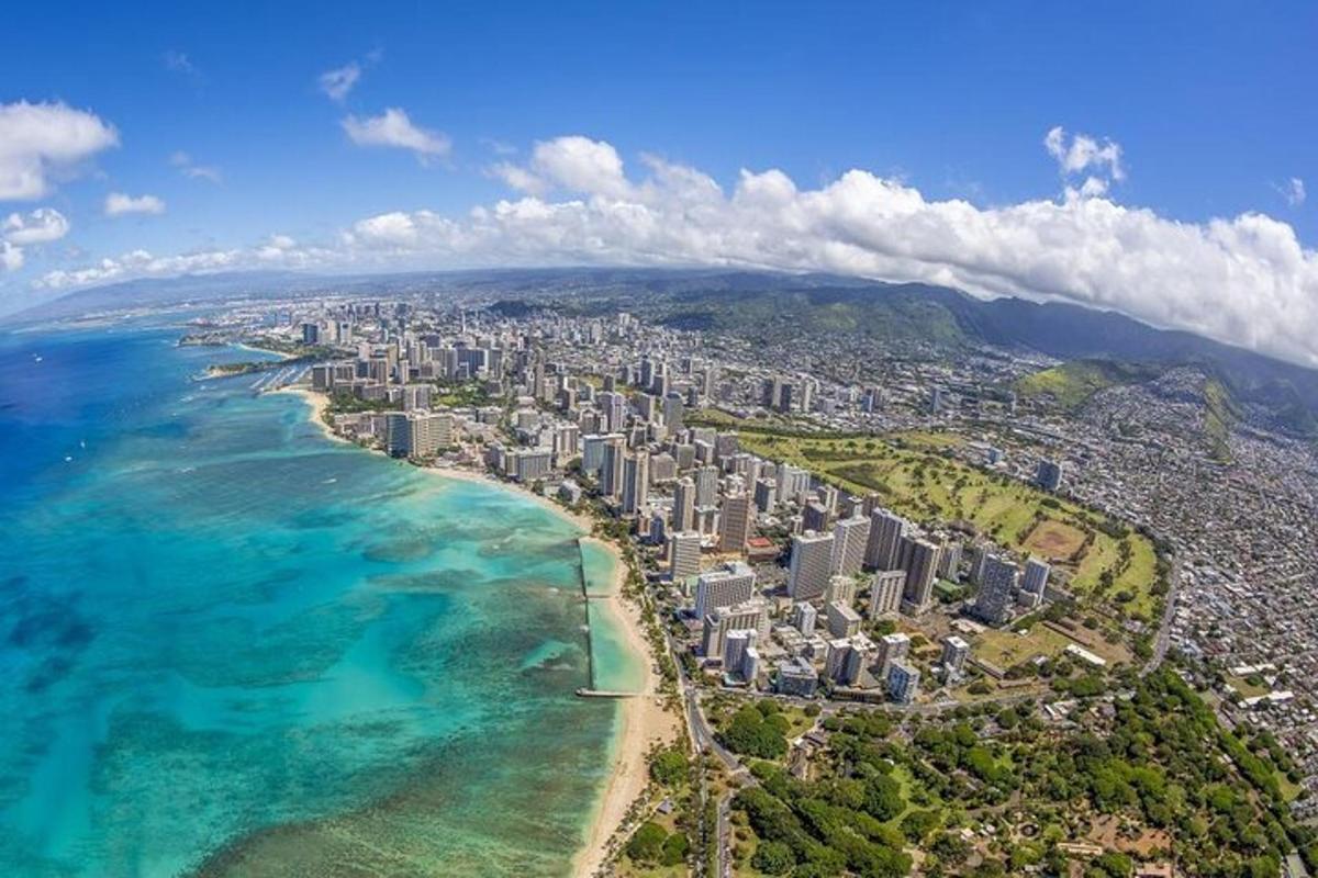 an aerial view of a city next to the ocean