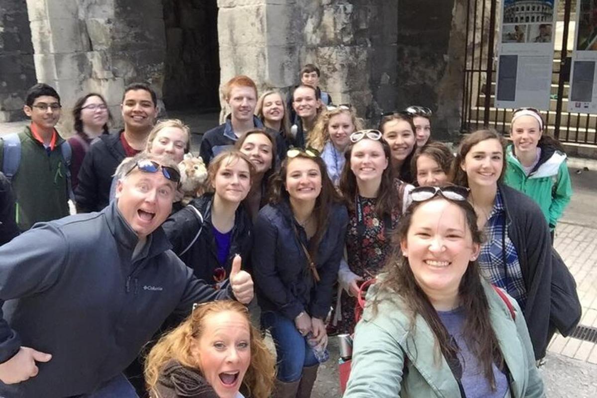 a group of people posing for a picture in front of a building