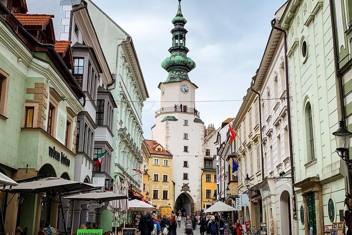 a street with a tall clock tower in a city