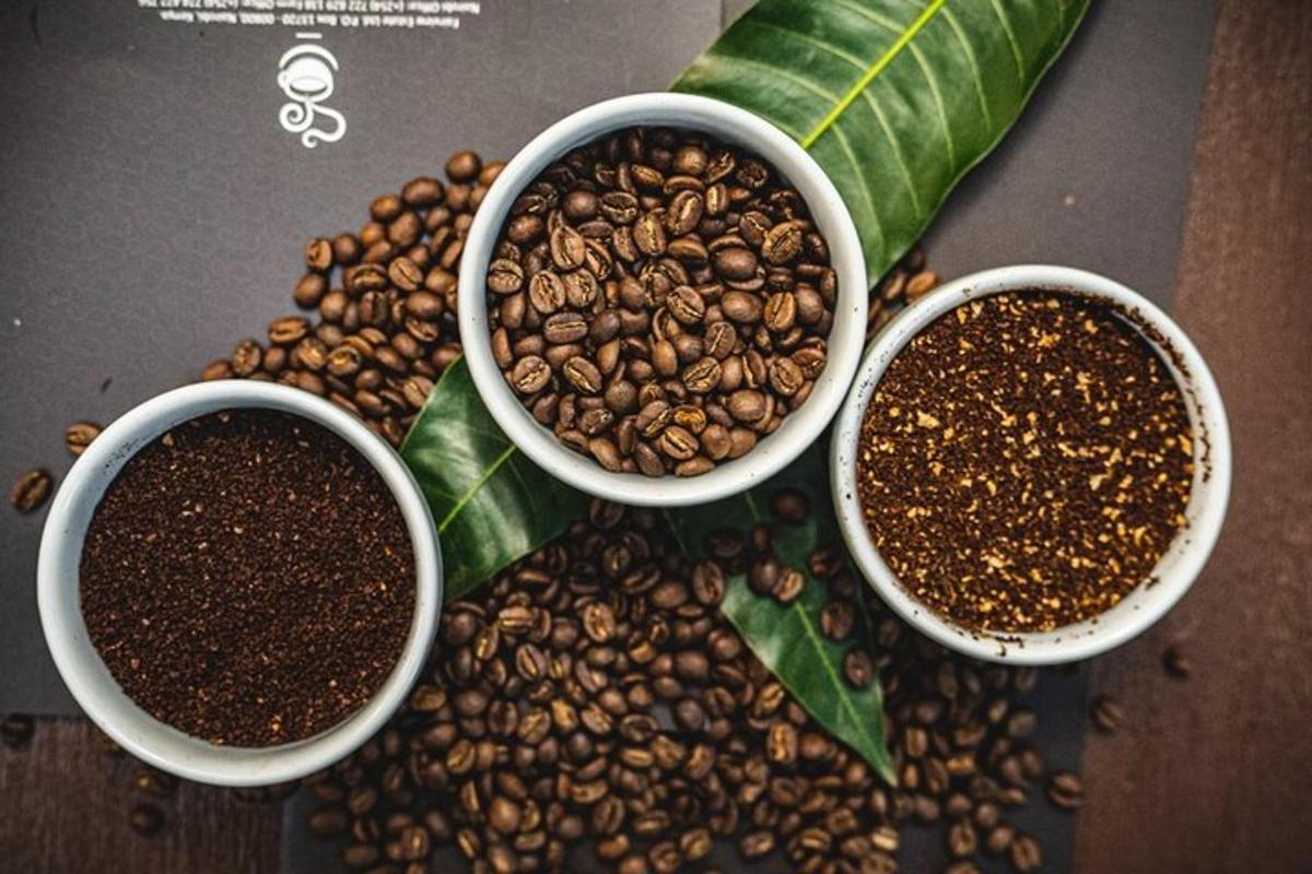 three cups of coffee sitting on top of coffee beans