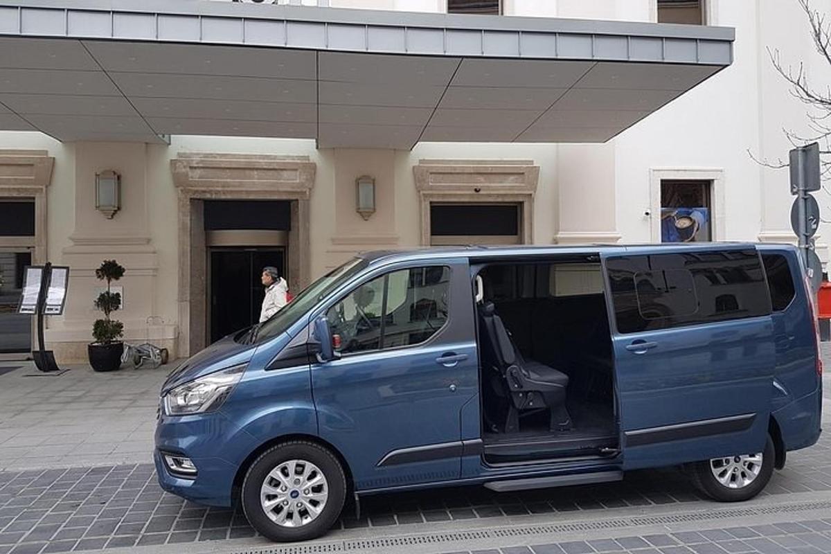 a blue van parked in front of a building