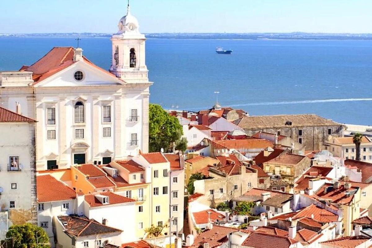 a view of a city with a church and the ocean