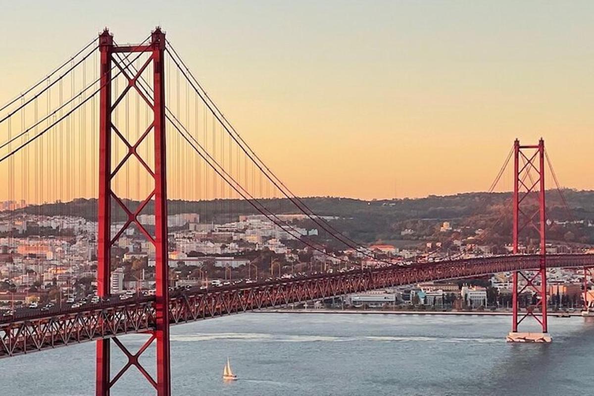 a red bridge over the water with a city