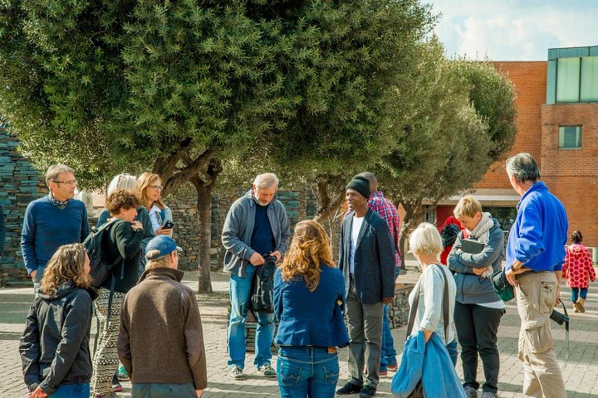 a group of people standing around under a tree