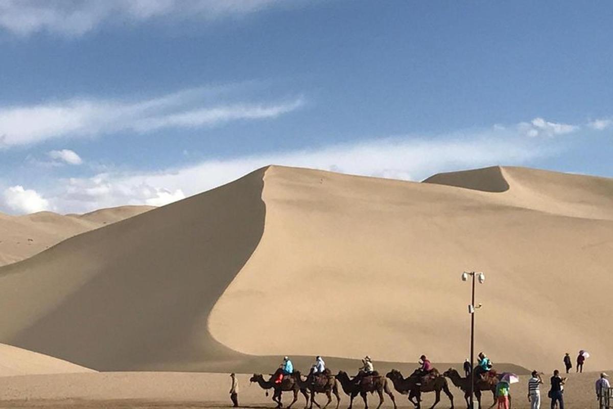 a group of people riding horses in the desert