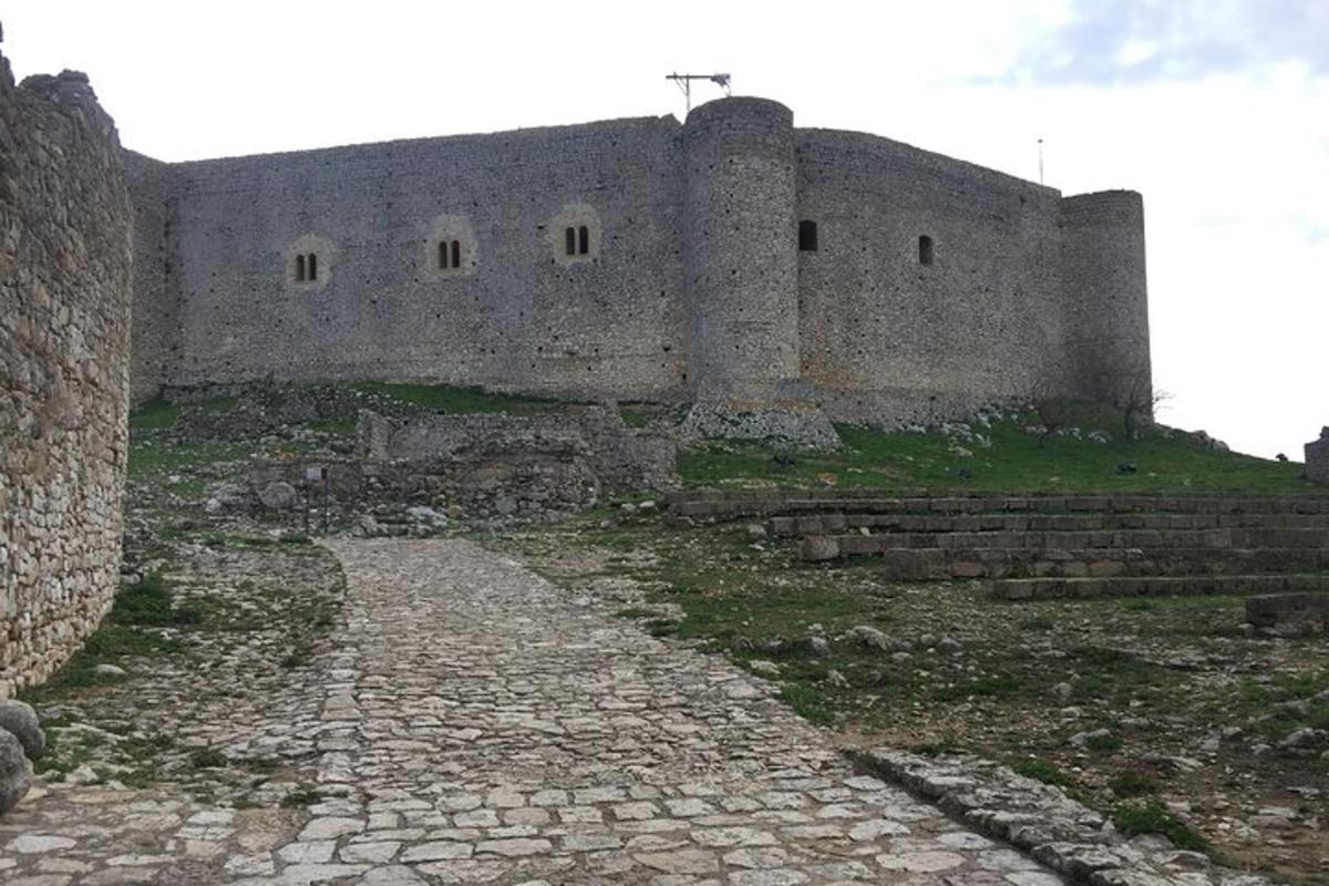 an old castle with a cobblestone street in front of it