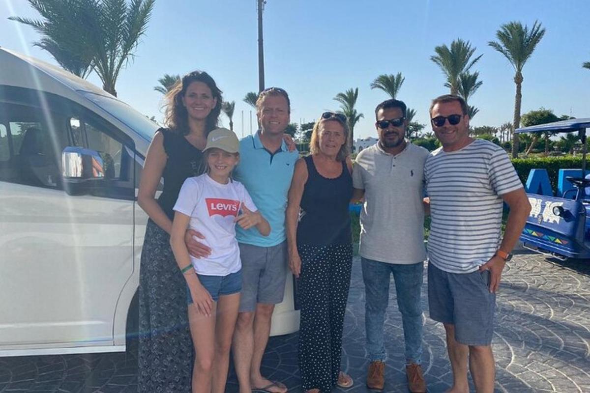 a group of people standing next to a white van