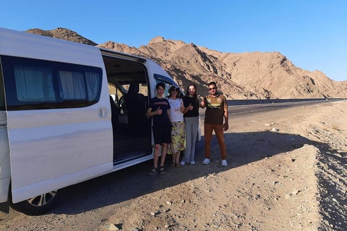 a group of people standing in front of a van