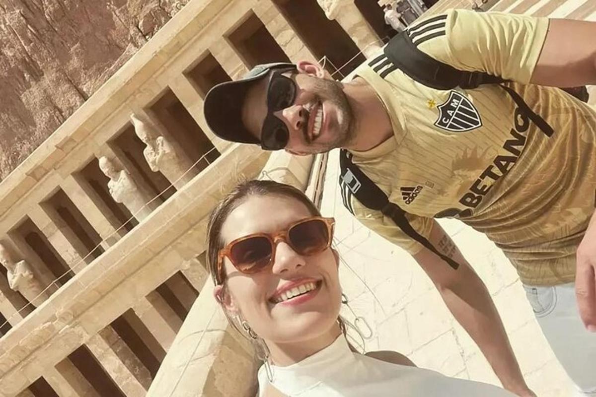 a man and a woman standing in front of a building