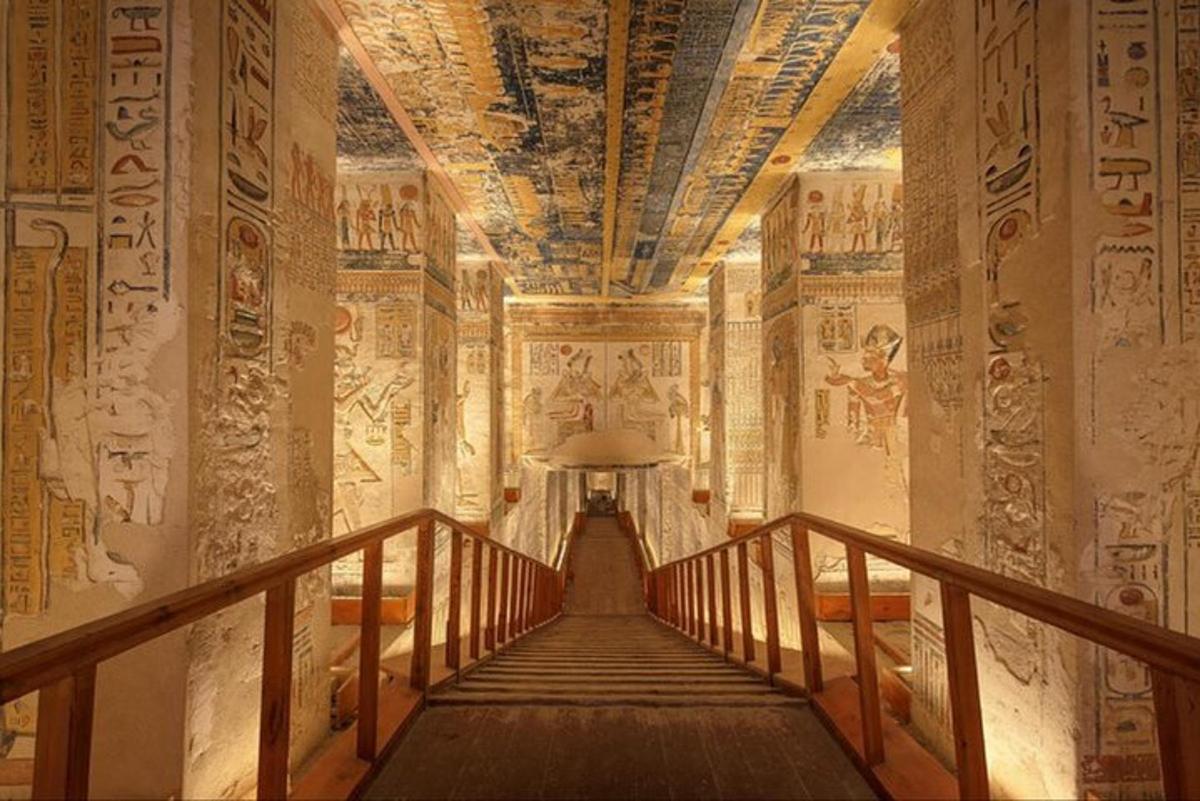 a hallway in an ancient building with paintings on the walls