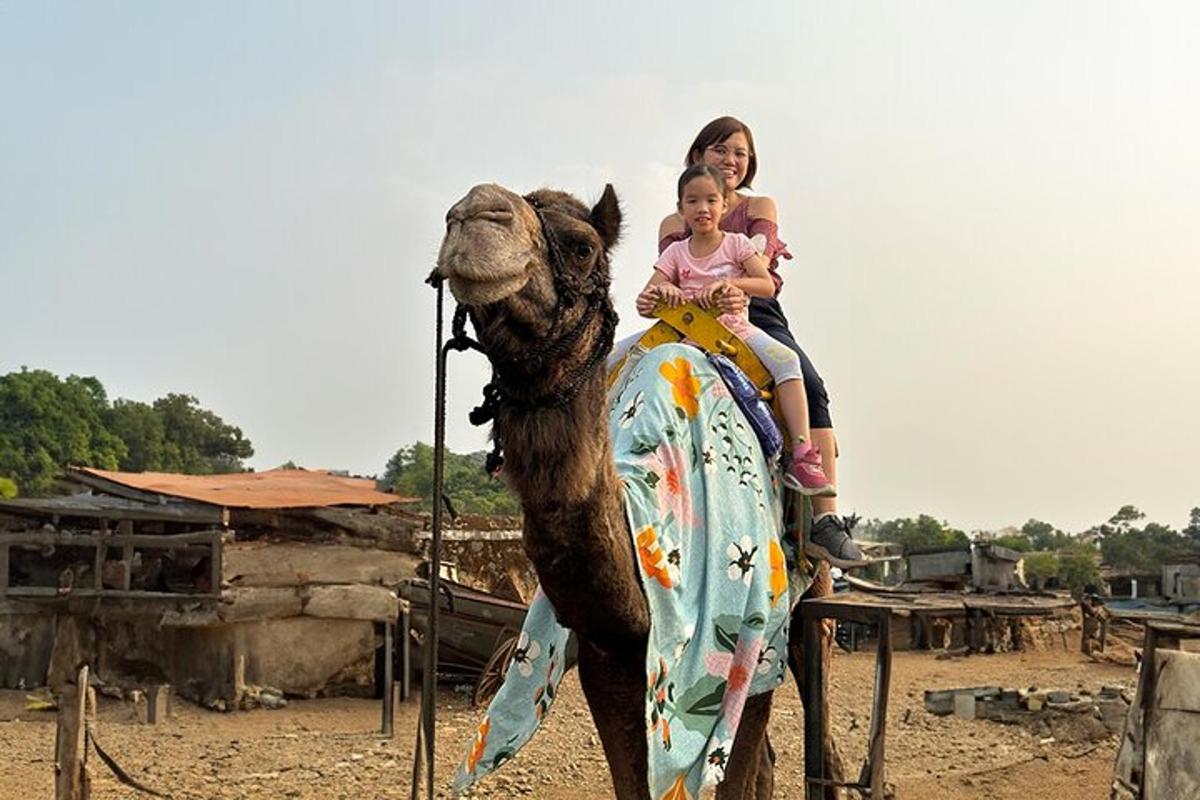 a woman and a child riding on a camel