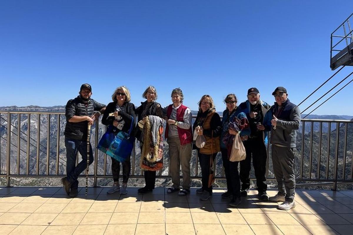 a group of people posing for a picture at the top of the observation deck